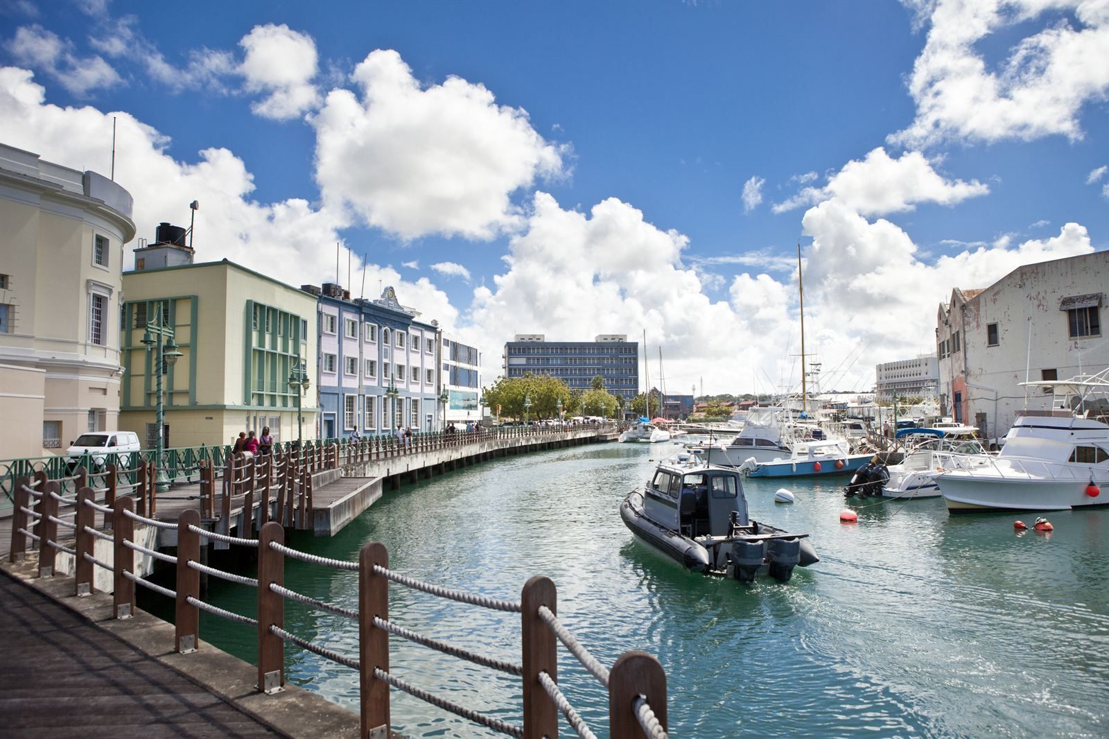 Boats moored in the Careenage beside a waterfront boardwalk in Bridgetown, Barbados