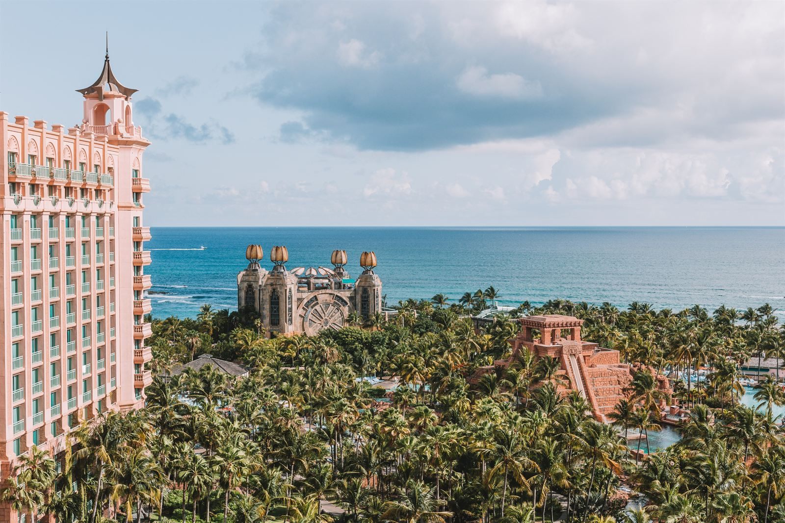 Pink resort towers and palm-filled grounds on Paradise Island, Nassau, with the ocean beyond