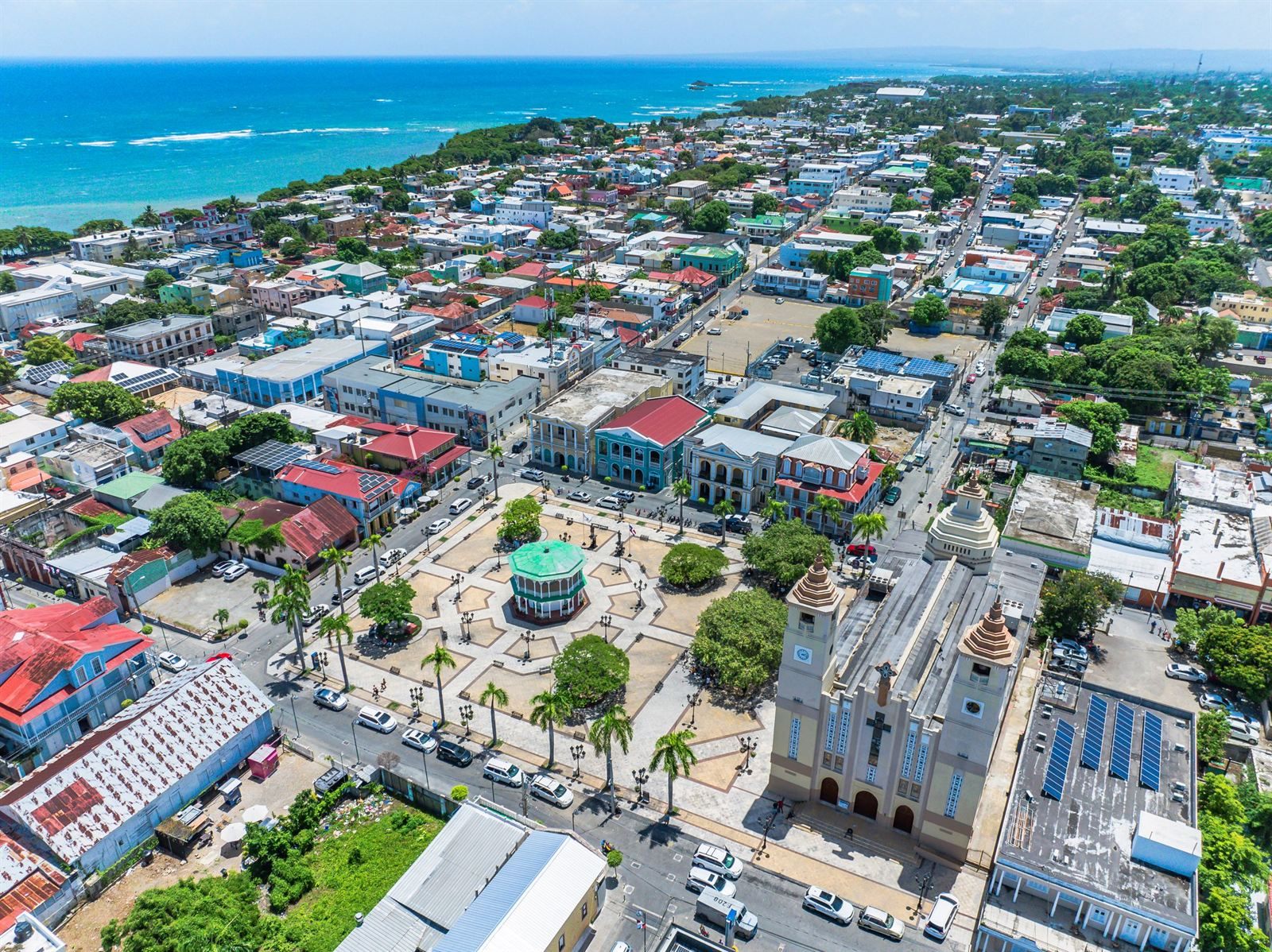 Aerial view of Puerto Plata with its central park gazebo, cathedral and the Atlantic coast beyond